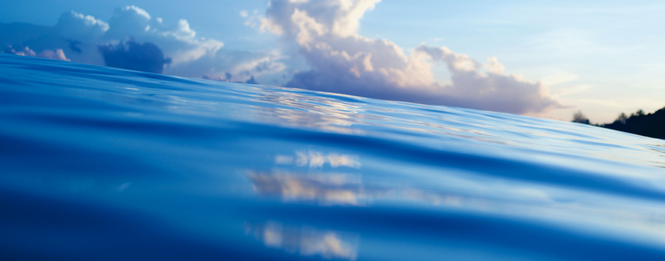 Ocean surface with clouds in the background on the horizon