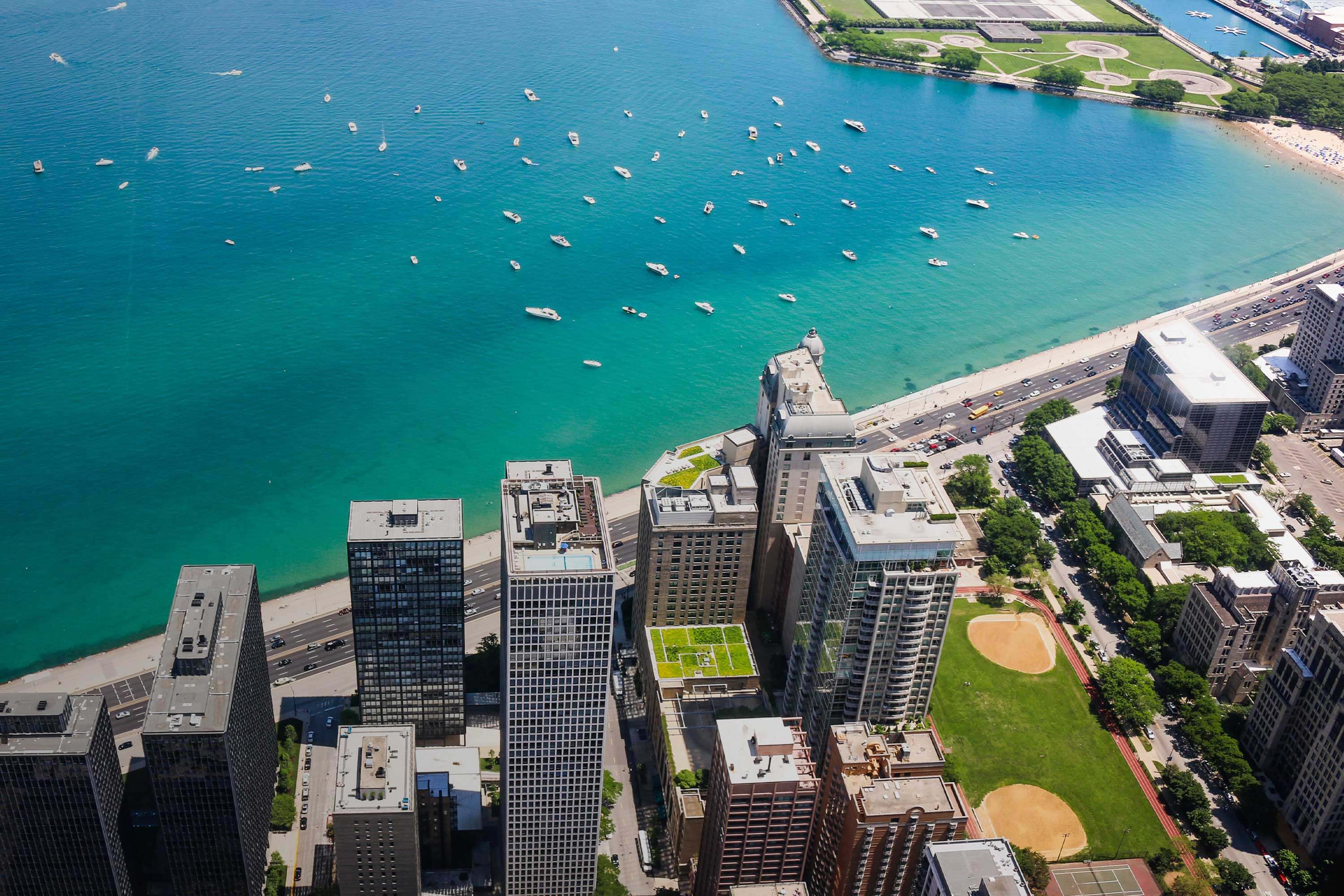 Large city buildings sit on the shore of a Great Lake